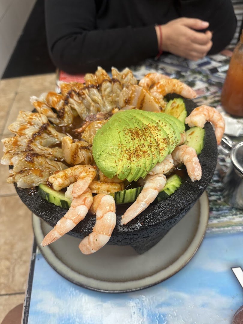 Unpretentious restaurant tables with plated seafood.
