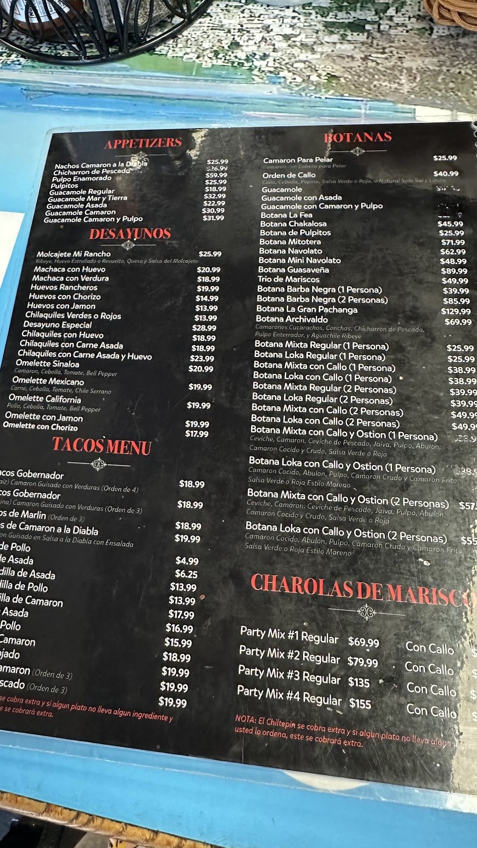 Printed menu with seafood and taco sections.